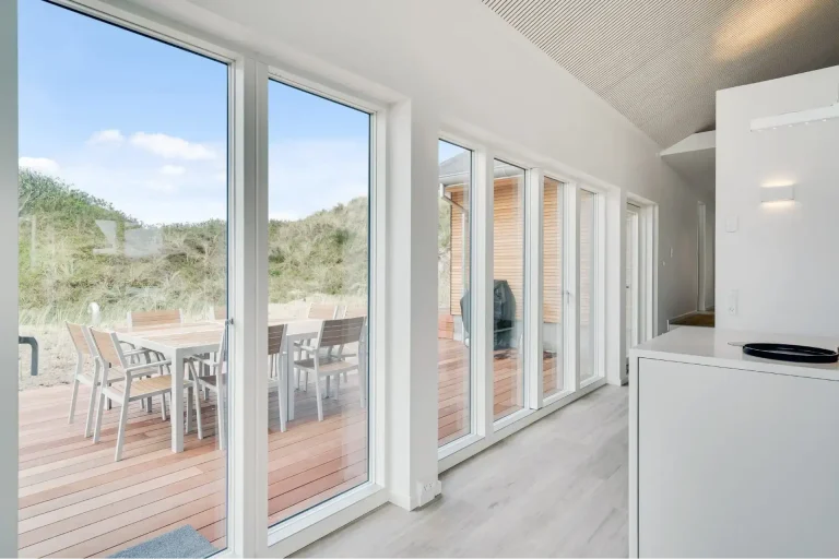 A long white sliding door from VELFAC's V200 collection