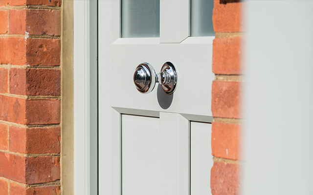 Close up of an optional centred door handle on evolutions timber effect front door